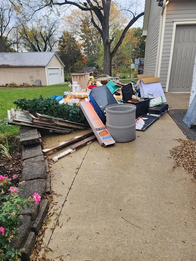 Dumpster being loaded with debris for 12 Yard Dumpster Rental in Oakbrook